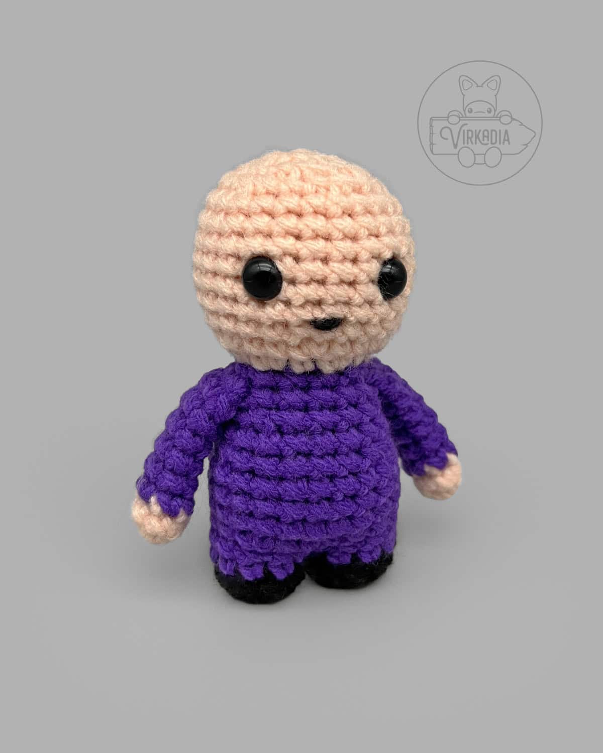 free Little Crochet Guy pattern with a purple body for DIY doll making, seasonal amigurumi projects, and holiday gifts